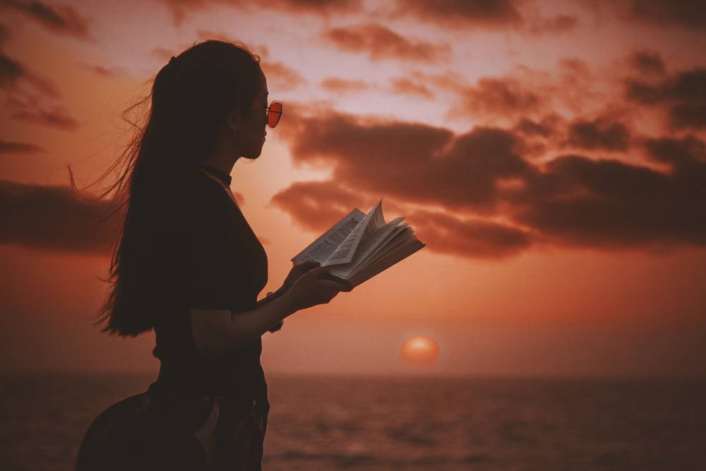 Girl-reading-book-during-sunset