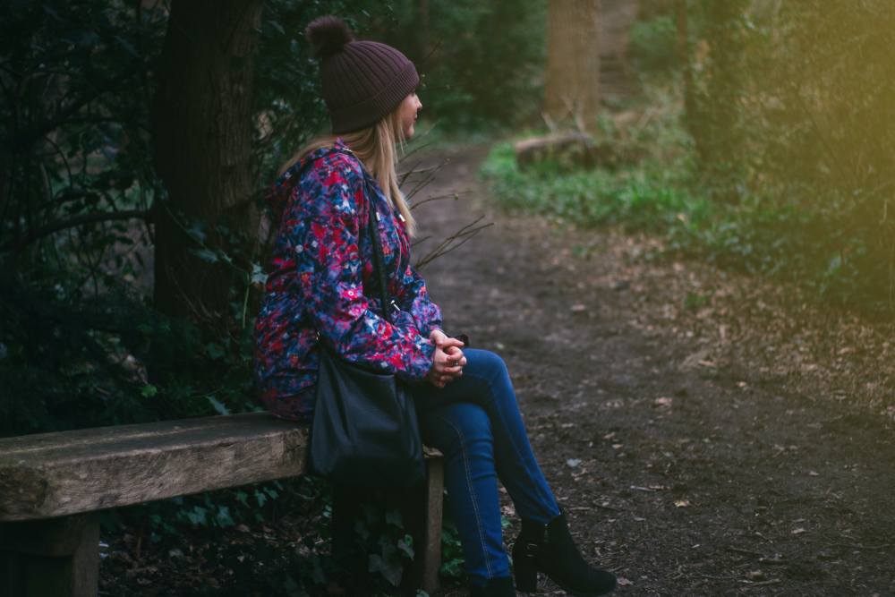 Girl sitting on a bench at the trail